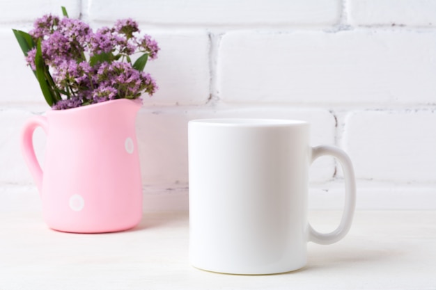 White coffee mug  with purple flowers in polka dot pink pitcher