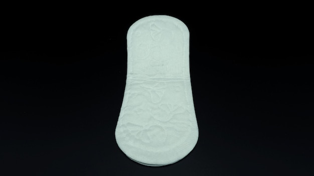 White color cotton sanitary pad for woman and black background