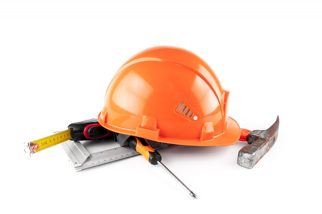 White construction helmet, tape measure, hammer, screwdriver. Concept architecture, construction, engineering, design, repair. Copy space.