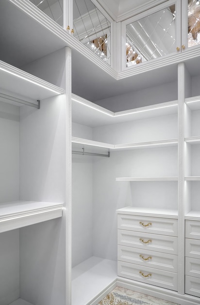 White corner wardrobe section with shelves in walkin closet