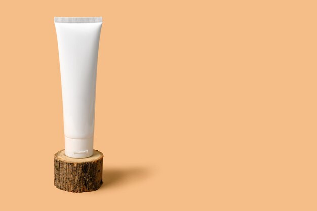 White cosmetic cream on a wooden podium. Place for your text.