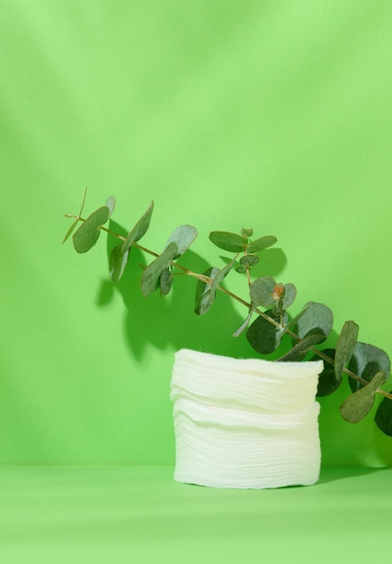 White cotton sponges on a green background