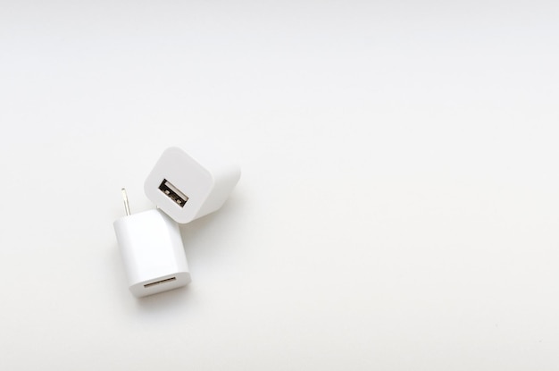 White cube shaped USB charger on white background