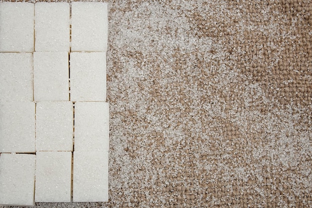 White cubes of refined sugar on a linen tablecloth