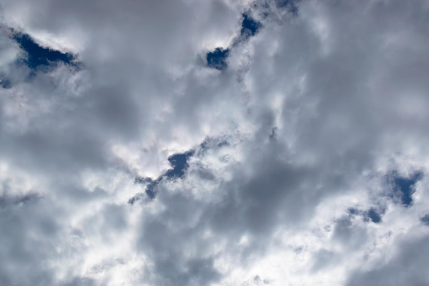 White cumulus clouds against a blue sky at noon