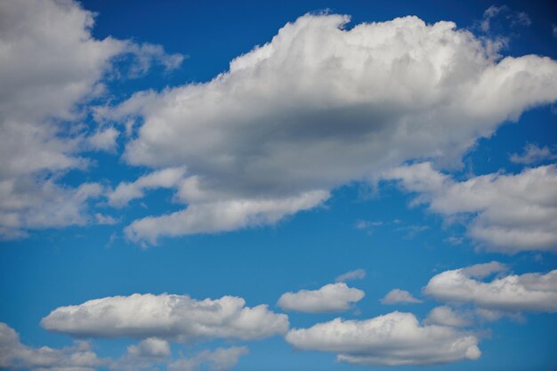 White cumulus clouds formation in blue sky in summer sunny day Cloudy blue sky Picturesque scenery Fickle weather