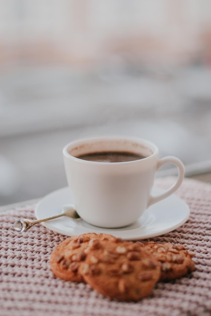 white cup of coffee breakfast a cup of tea cookies with nuts tea coffee