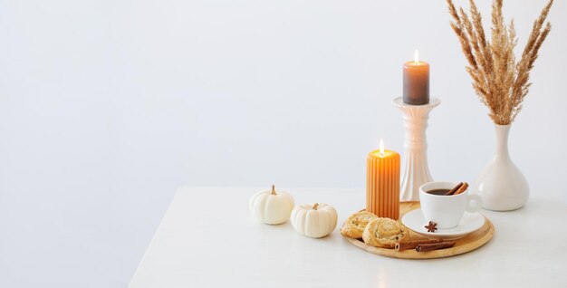 White cup of coffee with cozy decor on white table