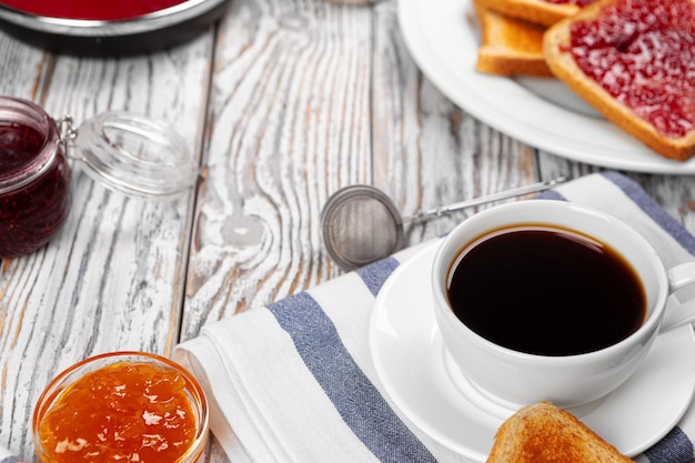 White cup of coffee on wooden kitchen table