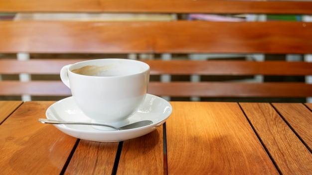 White cup of coffee on a wooden table