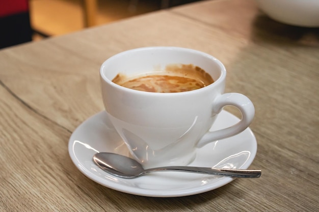 White cup of coffee on wooden table