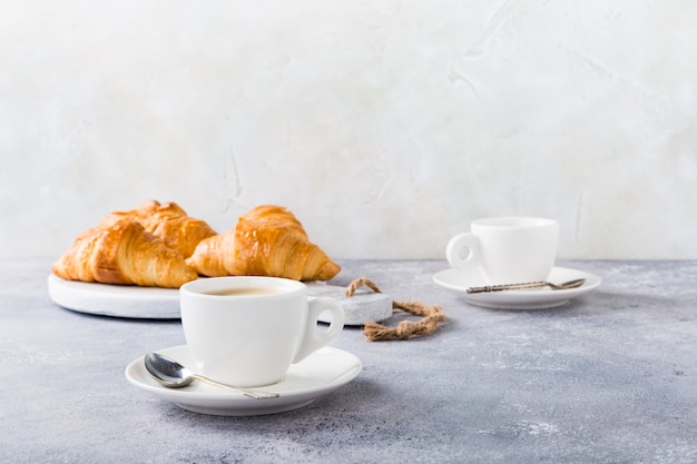 White cups of coffee and croissants