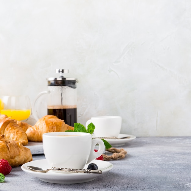 White cups of coffee and croissants