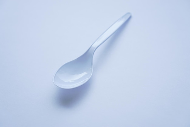 White disposable plastic spoon used for eating