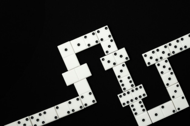 White dominoes chips combination on the black