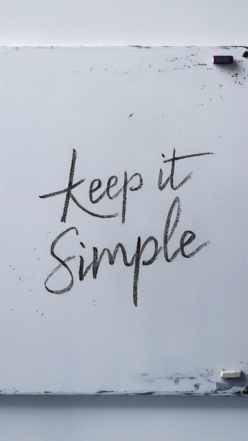 Photo white drawing board with the phrase keep it simple written on