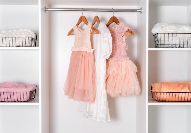 White dressing room with lush carnival dresses Storage organization concept