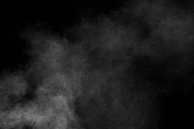 White dust cloud in the airAbstract white powder explosion against black background