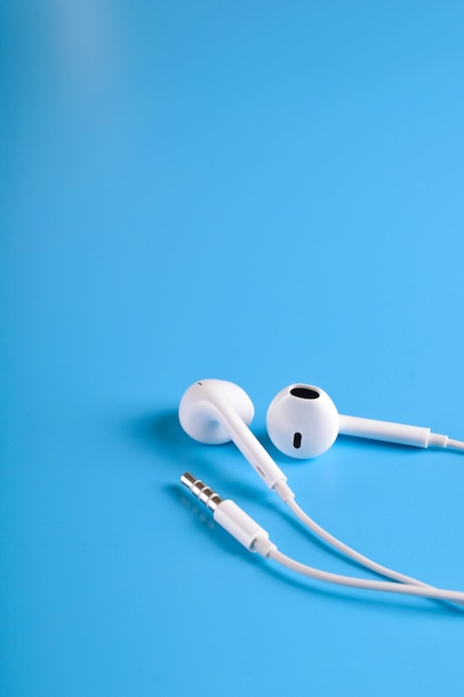 White earphones on blue table