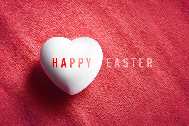 White egg in a heart shape with the words Happy Easter