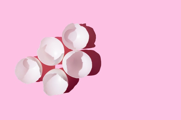 White eggshell on a pink background view from above