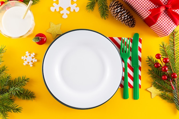 White empty plate and christmas table setting.