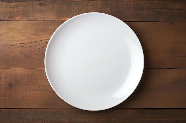 A white empty plate on a wooden table