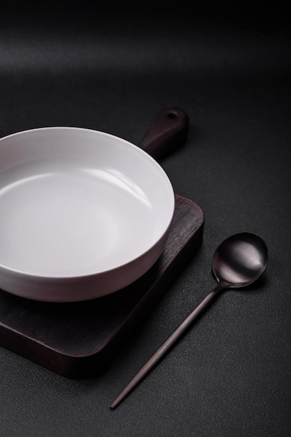 White empty soup bowl on a dark concrete background