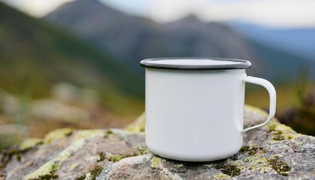 White enamel camping cup standing on rock Tasty beverage Delicious drink Morning in hiking camp