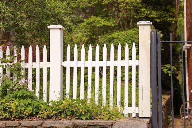 White fence in sunlight signifies purity renewal tranquility and the arrival of spring's vibrant