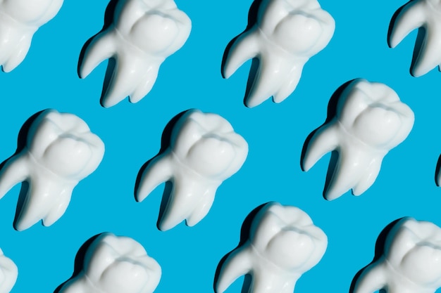 White figures of teeth on a blue background Dentistry concept