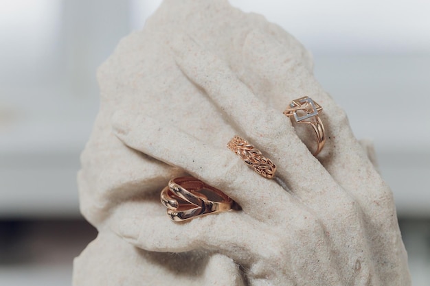 White figurines with wedding rings on closeup