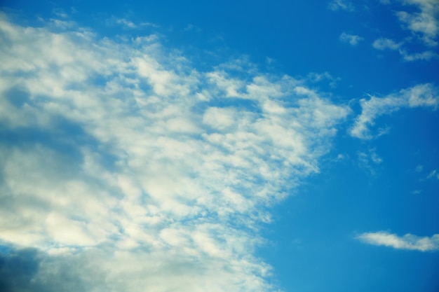 White flat cumulus clouds formation in blue sky in summer sunny day Cloudy blue sky Dramatic cloudscape Fickle weather