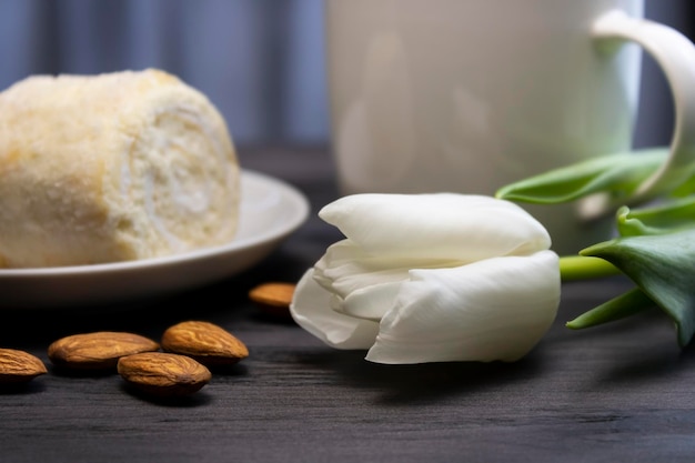 White flower with coffee and sponge cake with almonds