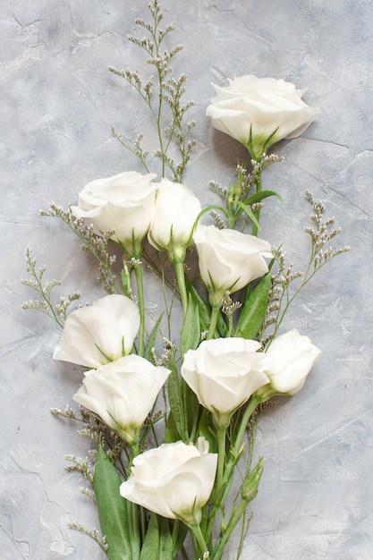 White flowers on a grey background top view