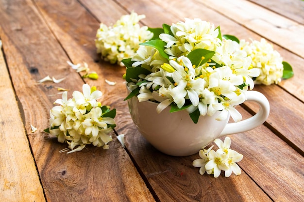 white flowers jasmine in cup arrangement postcard style