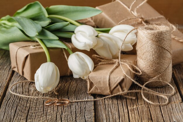 White flowers tulip on present box on table