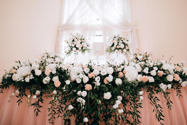 White flowers on a wedding table in a restaurant Decorating a restaurant for a festive dinner