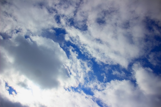 White fluffy clouds on a background of blue sky.