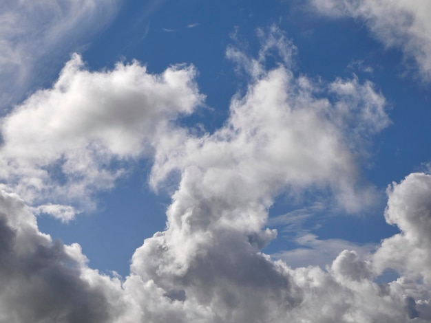 White fluffy clouds over blue sky background beautiful heaven photo