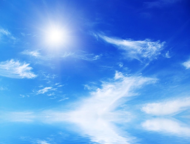 White fluffy clouds with rainbow in the blue sky