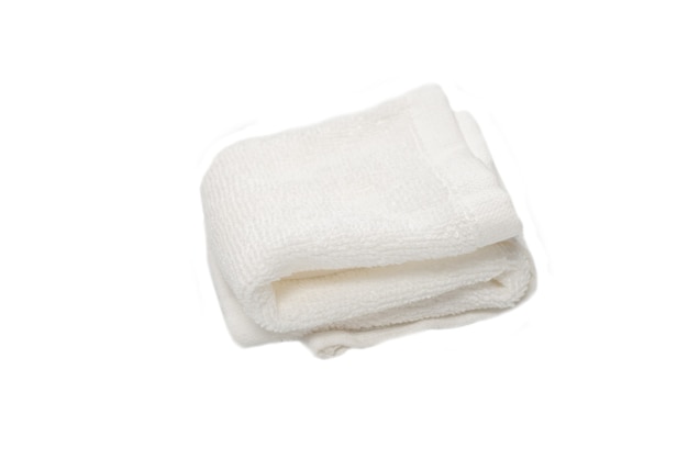 White fluffy cotton towel isolated on a white background. Spa and resort.