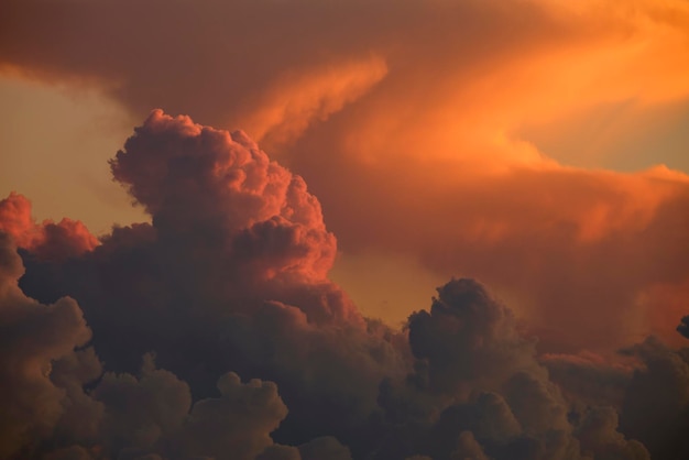 White fluffy cumulonimbus clouds forming before thunderstorm on evening sky Changing stormy cloudscape weather at sunset