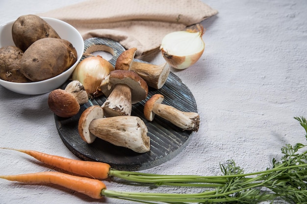 White forest mushrooms on a light background Cooking organic mushrooms