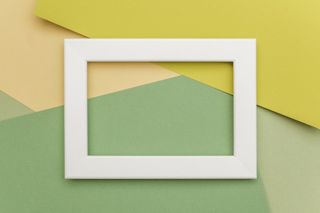 White frame on geometric green shades paper background.