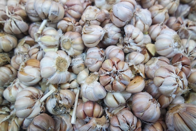 White garlic pile texture Fresh garlic on market table closeup photo Vitamin healthy food spice im