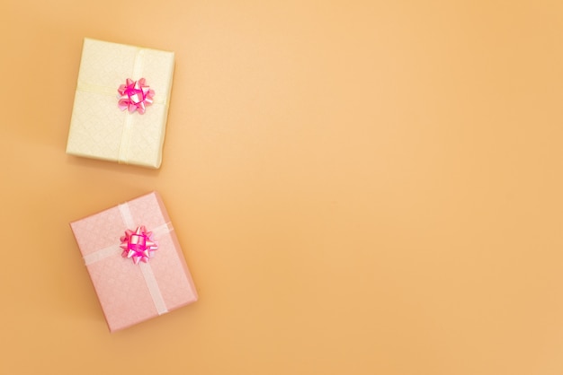 White Gift box with Blue ribbon on Pink background for copy space. 