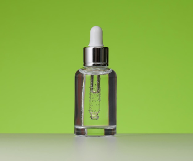 White glass bottle with pipette for cosmetics oils and serum Advertising and product promotion