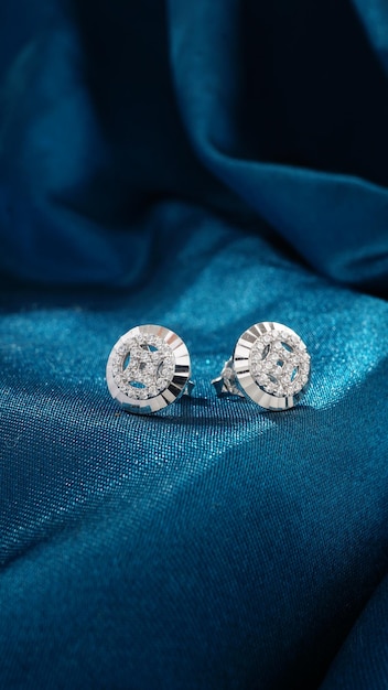 White Gold Diamond Earrings Isolated on blue background