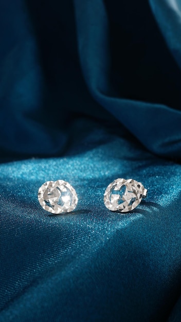 White Gold Diamond Earrings Isolated on blue background